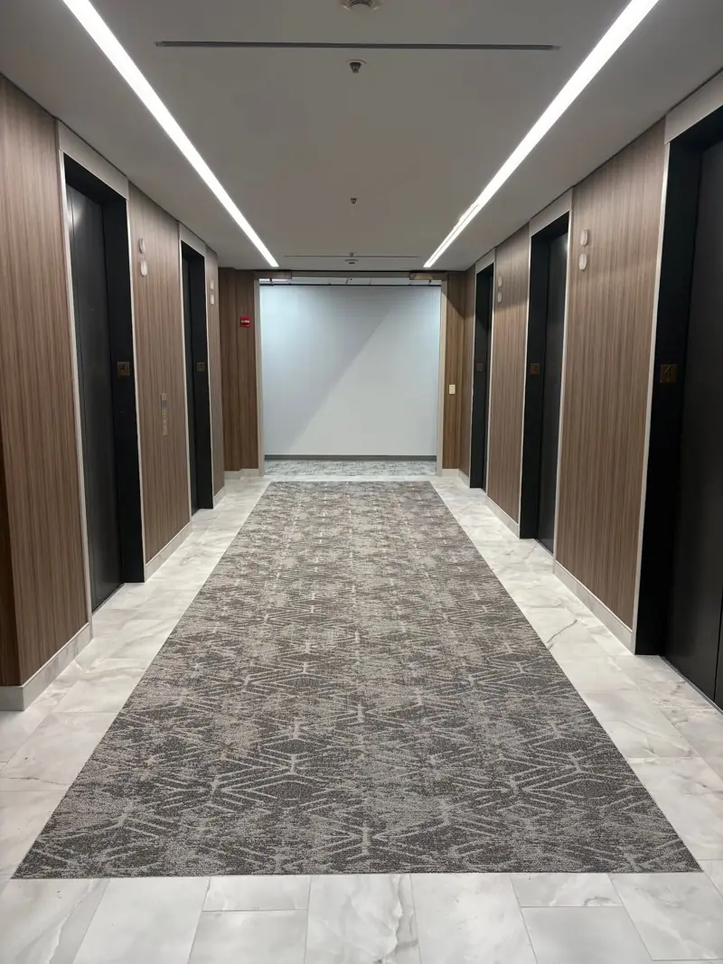 Elevator lobby with carpet inset and porcelain border