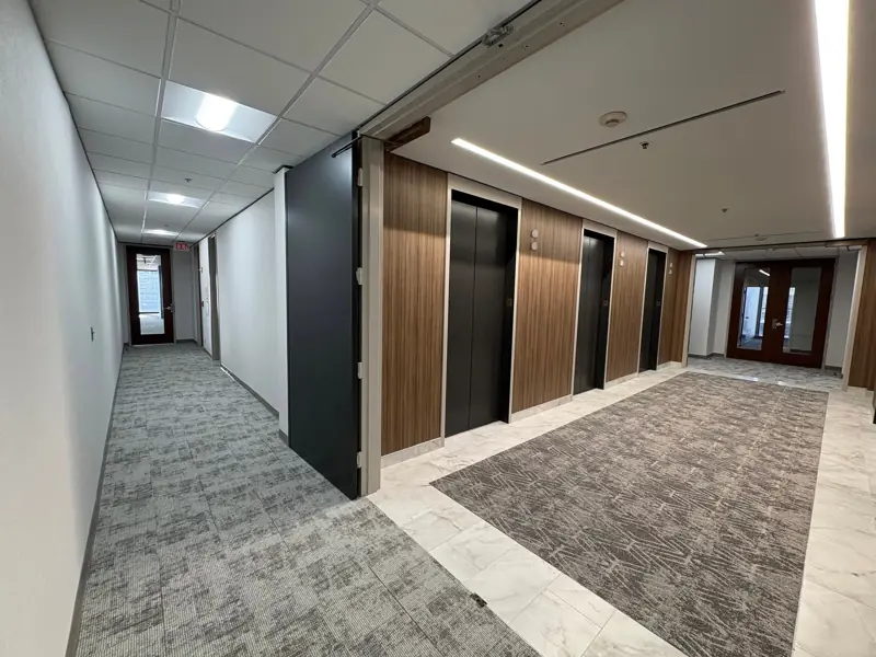 Elevator lobby with porcelain tile and carpet runner