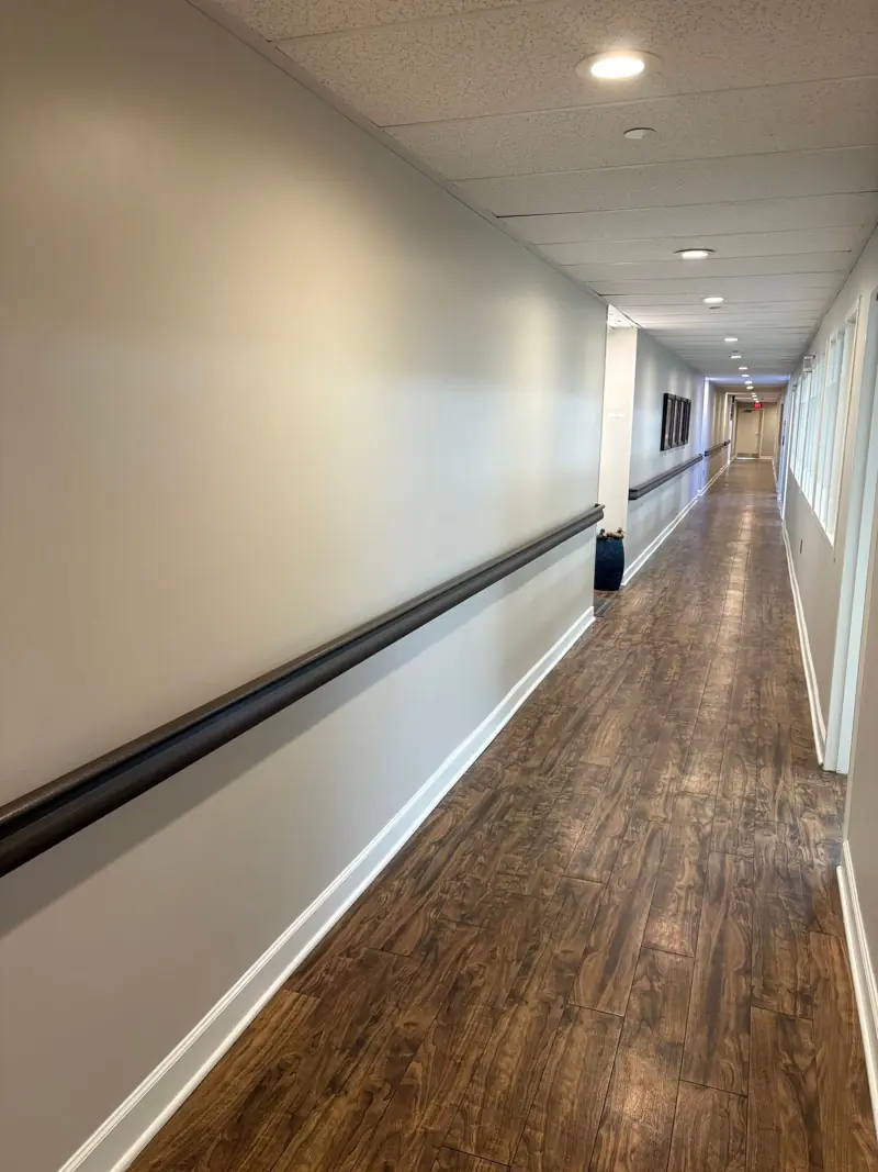 Corridor with wood-look luxury vinyl plank and handrail