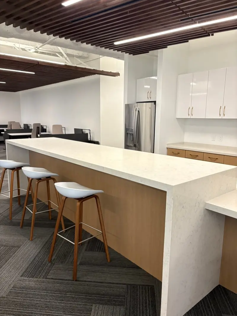 Office break room with quartz waterfall island